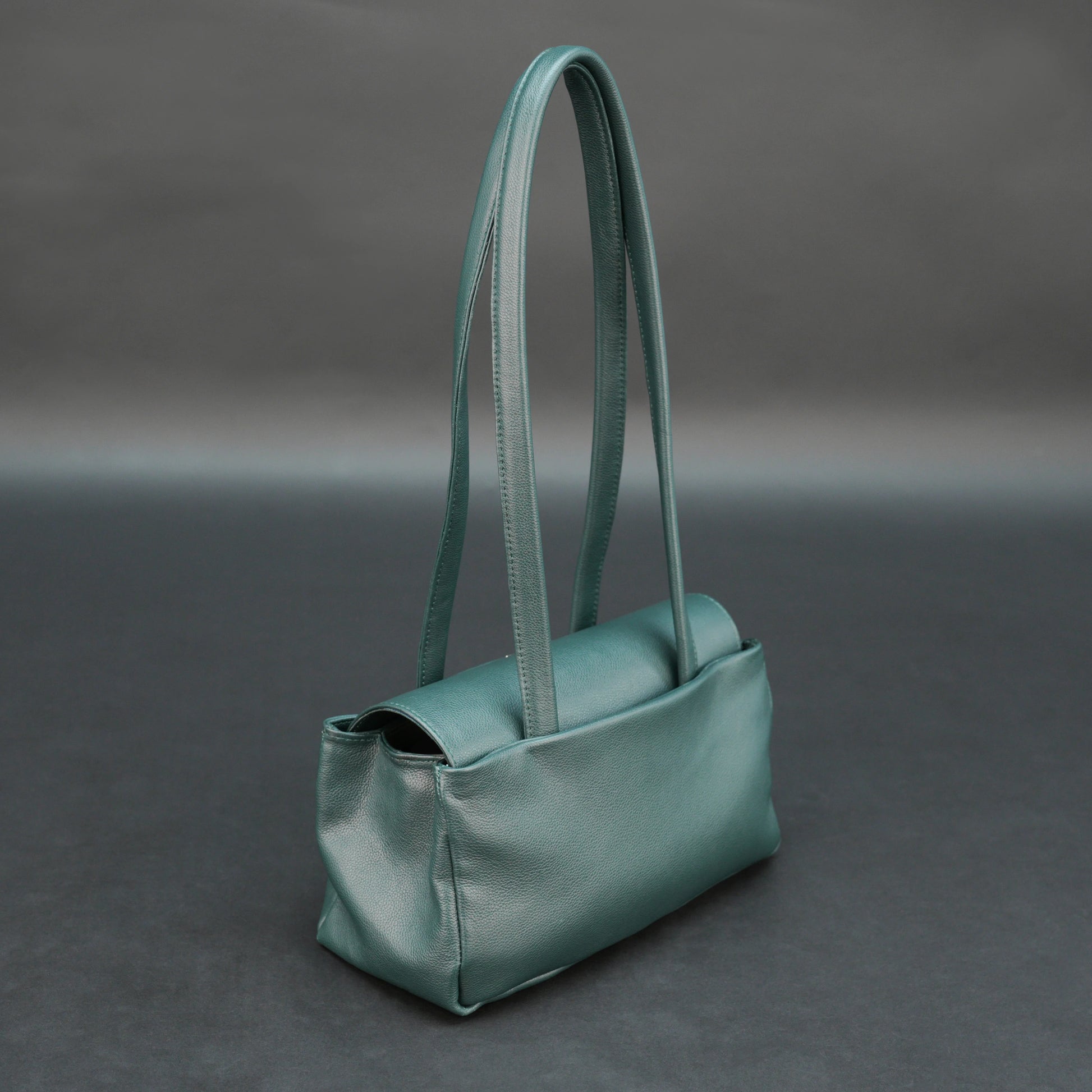 Deep jade cow Bamie leather bag with straps, dual compartments, and zipper pocket.