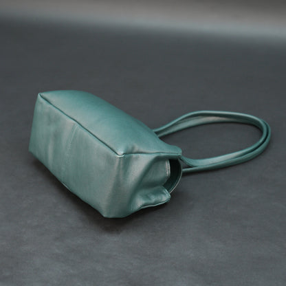 Deep jade cow Bamie leather bag with straps, dual compartments, and zipper pocket.