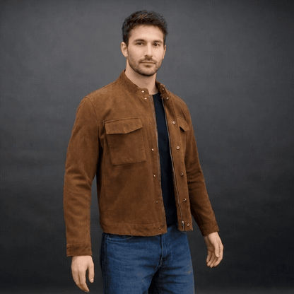 Men’s brown suede leather jacket with button-zip closure, front pocket, and modern fit, combining rugged durability with a refined silhouette