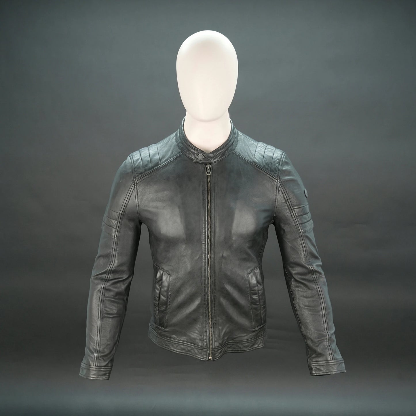 Black leather jacket with mandarin collar, quilted shoulders, and slim fit.