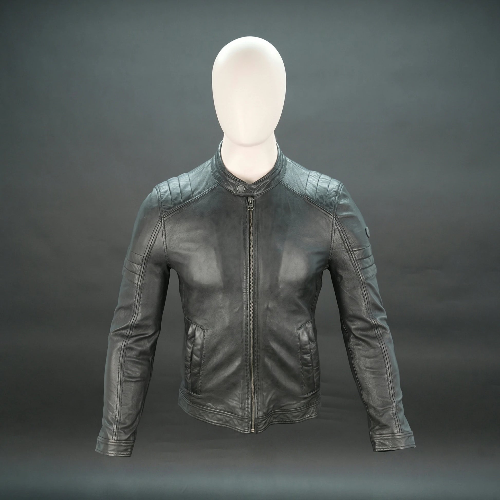 Black leather jacket with mandarin collar, quilted shoulders, and slim fit.