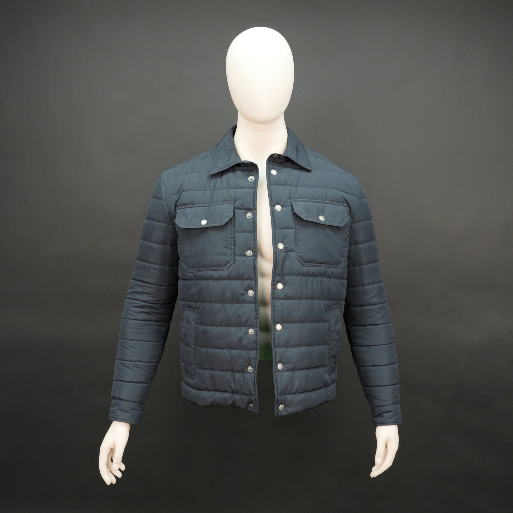 Men’s navy button-down quilted puffer jacket with six pockets, full sleeves, and snap closure.