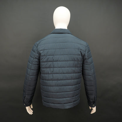 Men’s navy button-down quilted puffer jacket with six pockets, full sleeves, and snap closure.