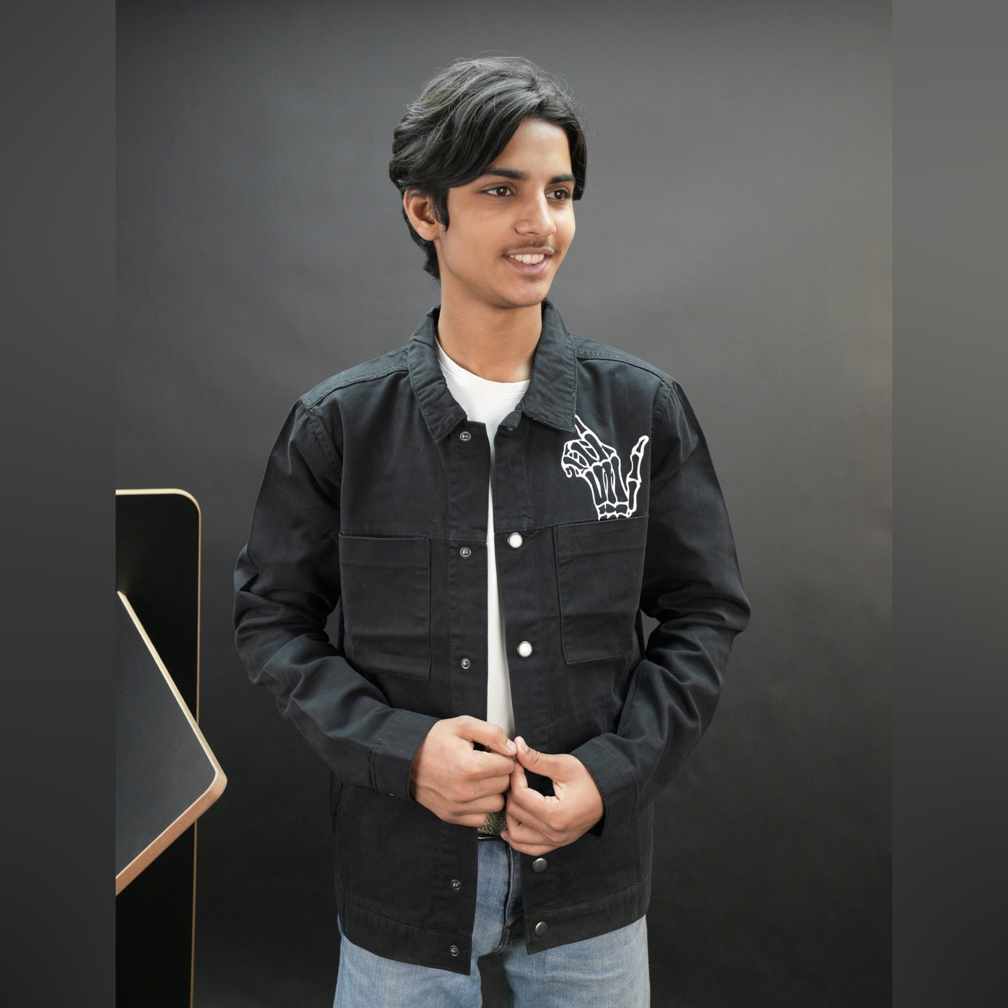 Men’s black denim jacket with bold finger print graphic, button-down front, adjustable cuffs, and side pockets, casual relaxed fit