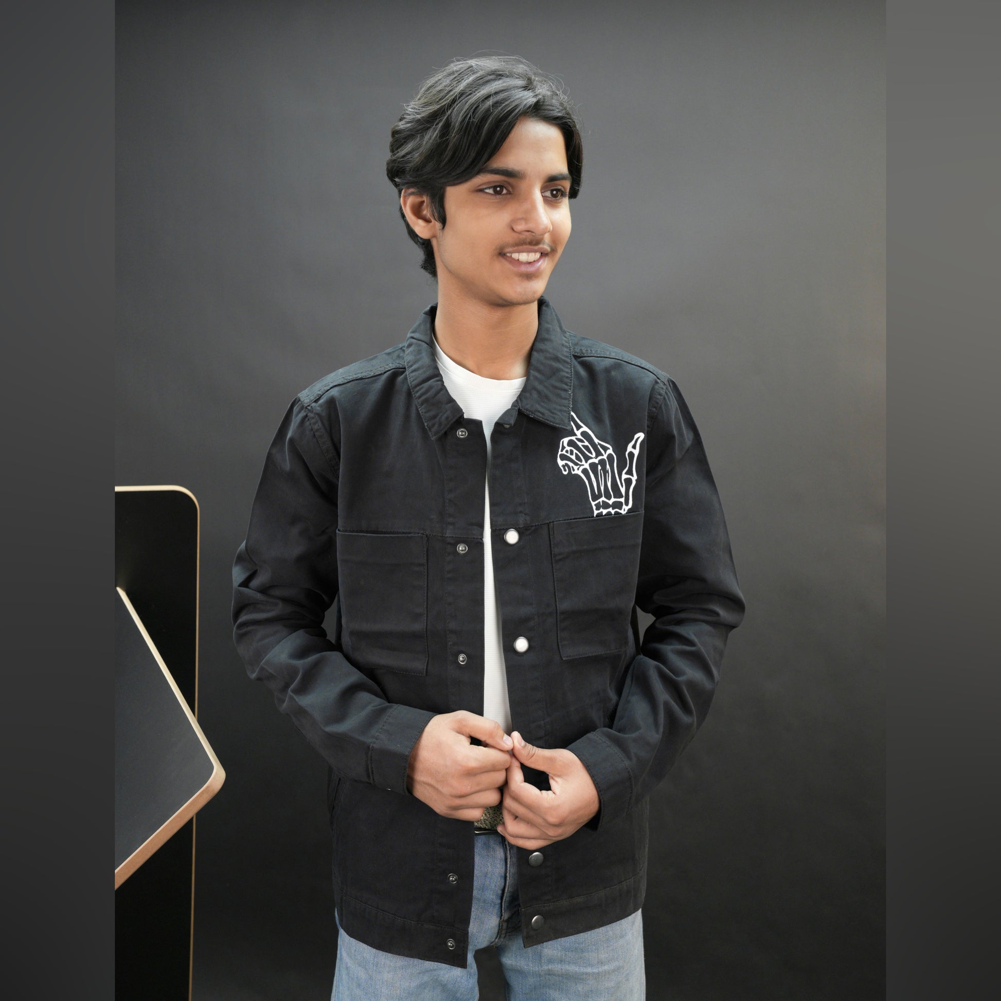 Men’s black denim jacket with bold finger print graphic, button-down front, adjustable cuffs, and side pockets, casual relaxed fit