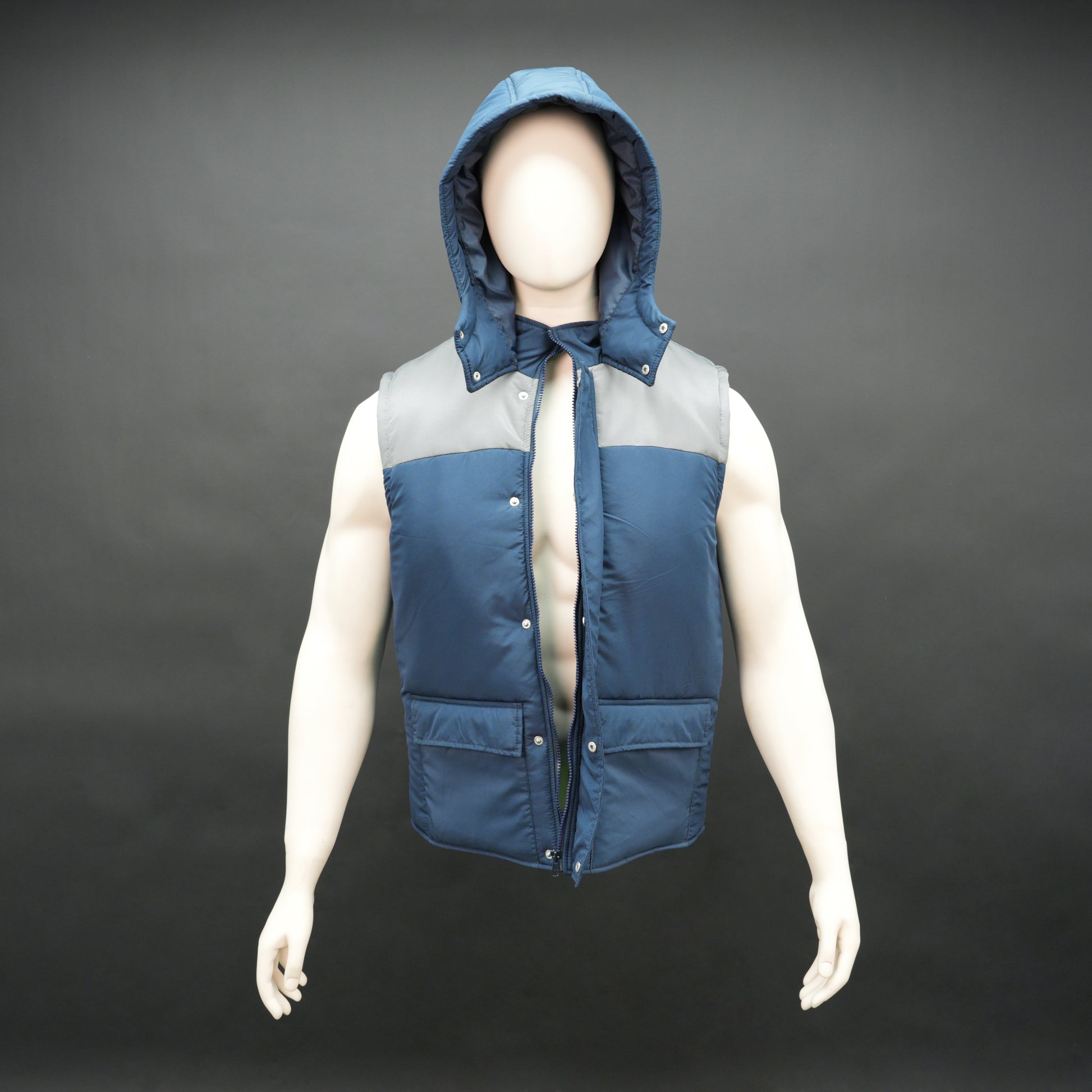Men’s blue/grey hooded sleeveless puffer vest with zip and snap closure, lightweight and pocketed.