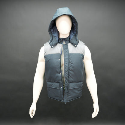 Men’s navy/grey hooded sleeveless puffer vest with zip and snap closure, lightweight and pocketed.