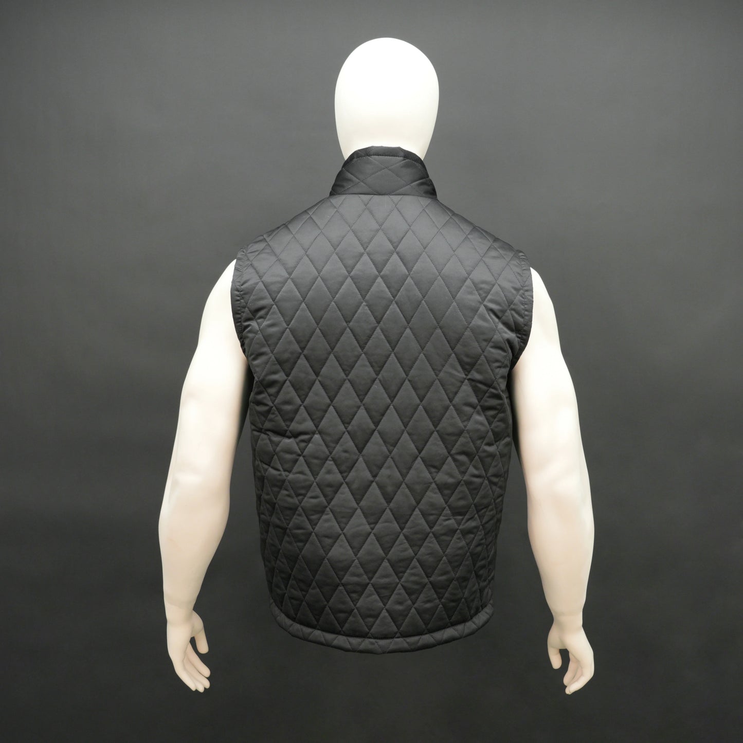 Black sleeveless quilted jacket with front zip, lightweight fabric, and multiple pockets