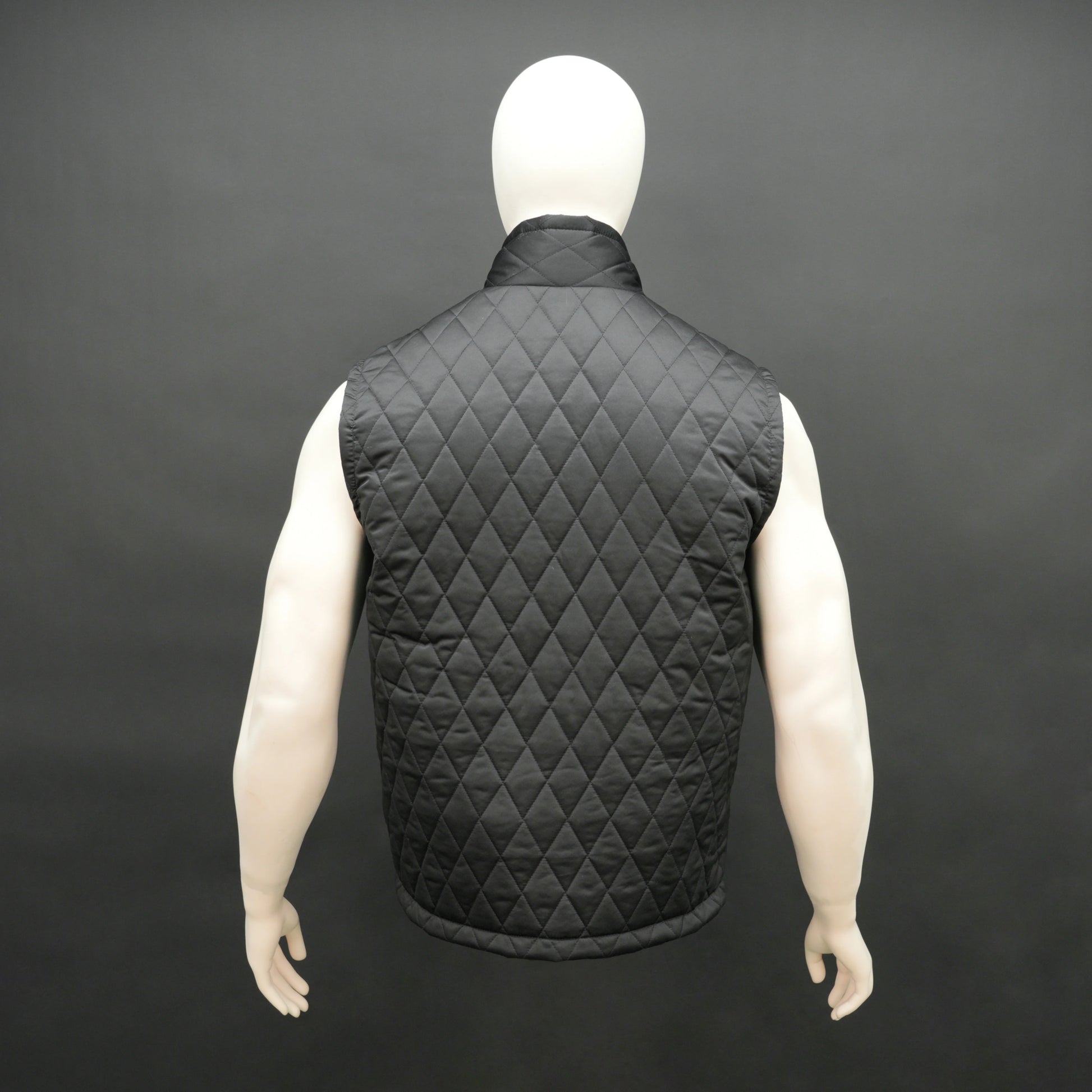 Black sleeveless quilted jacket with front zip, lightweight fabric, and multiple pockets