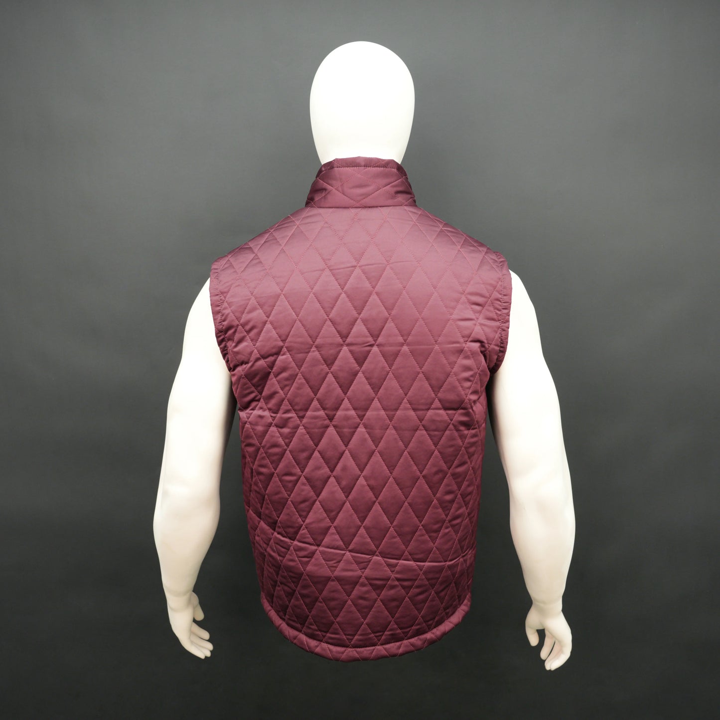 Maroon sleeveless quilted jacket with front zip, lightweight fabric, and multiple pockets