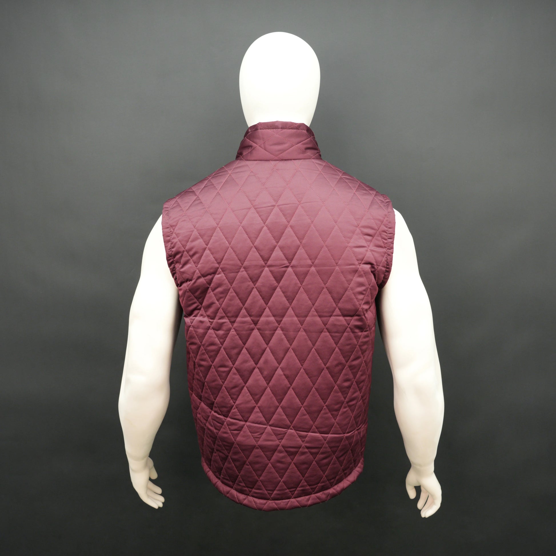 Maroon sleeveless quilted jacket with front zip, lightweight fabric, and multiple pockets
