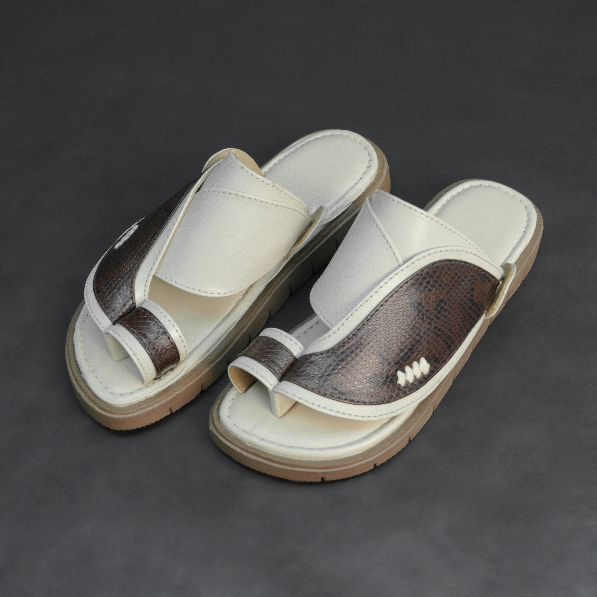 Off-white Arabic chappal with snake-pattern PU upper and EVA sole.