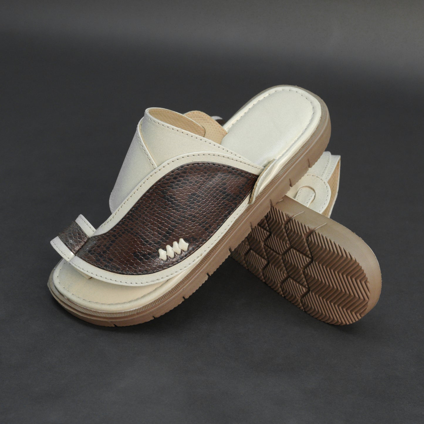 Off-white Arabic chappal with snake-pattern PU upper and EVA sole.