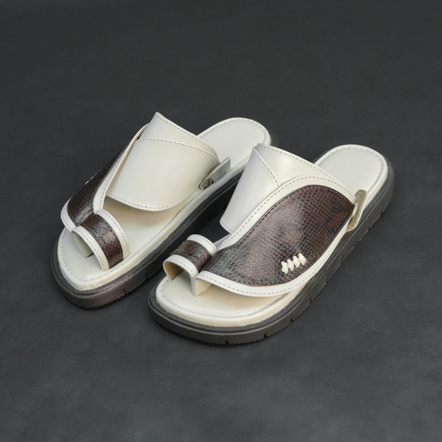 Off-white Arabic chappal with snake-pattern PU upper and EVA sole.