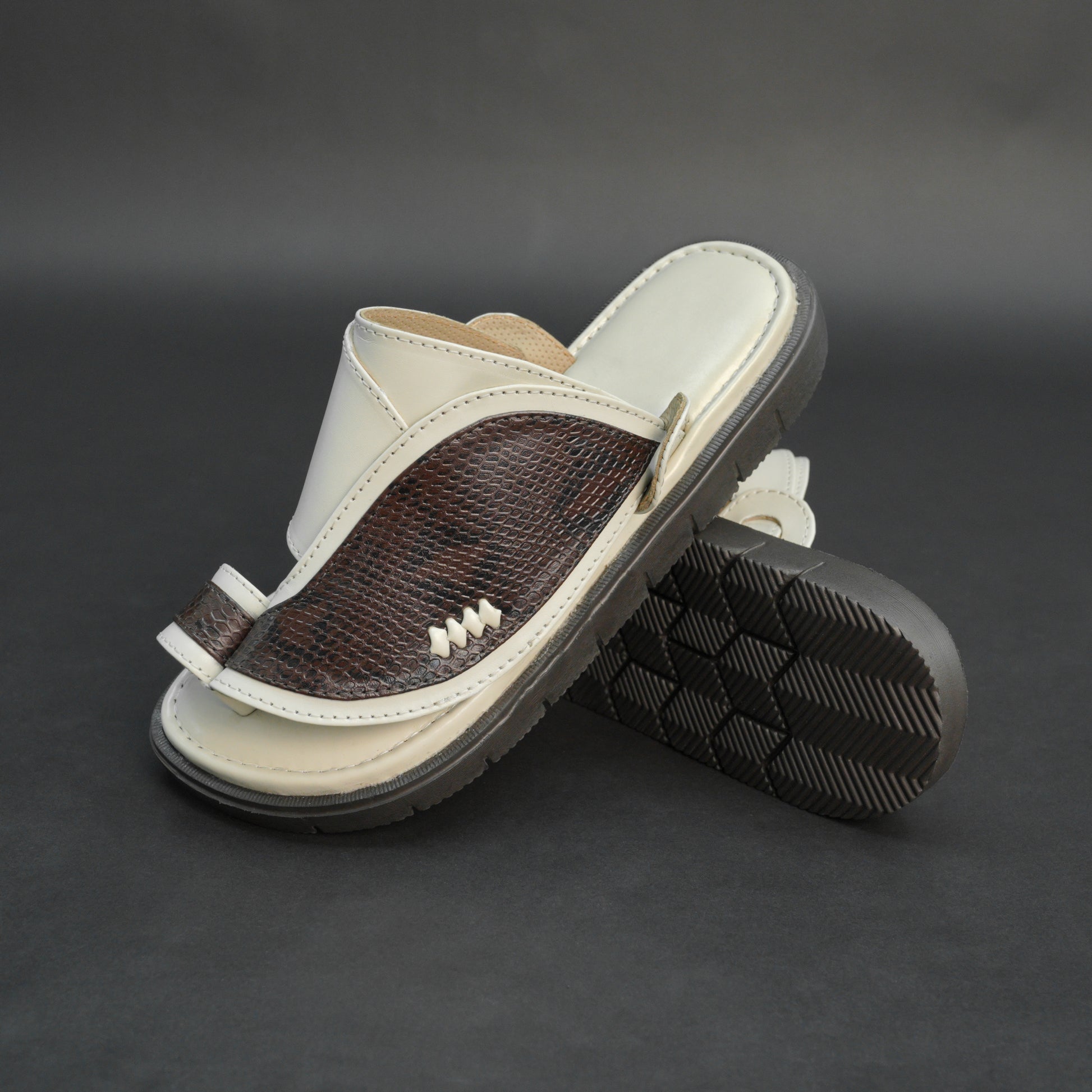 Off-white Arabic chappal with snake-pattern PU upper and EVA sole.