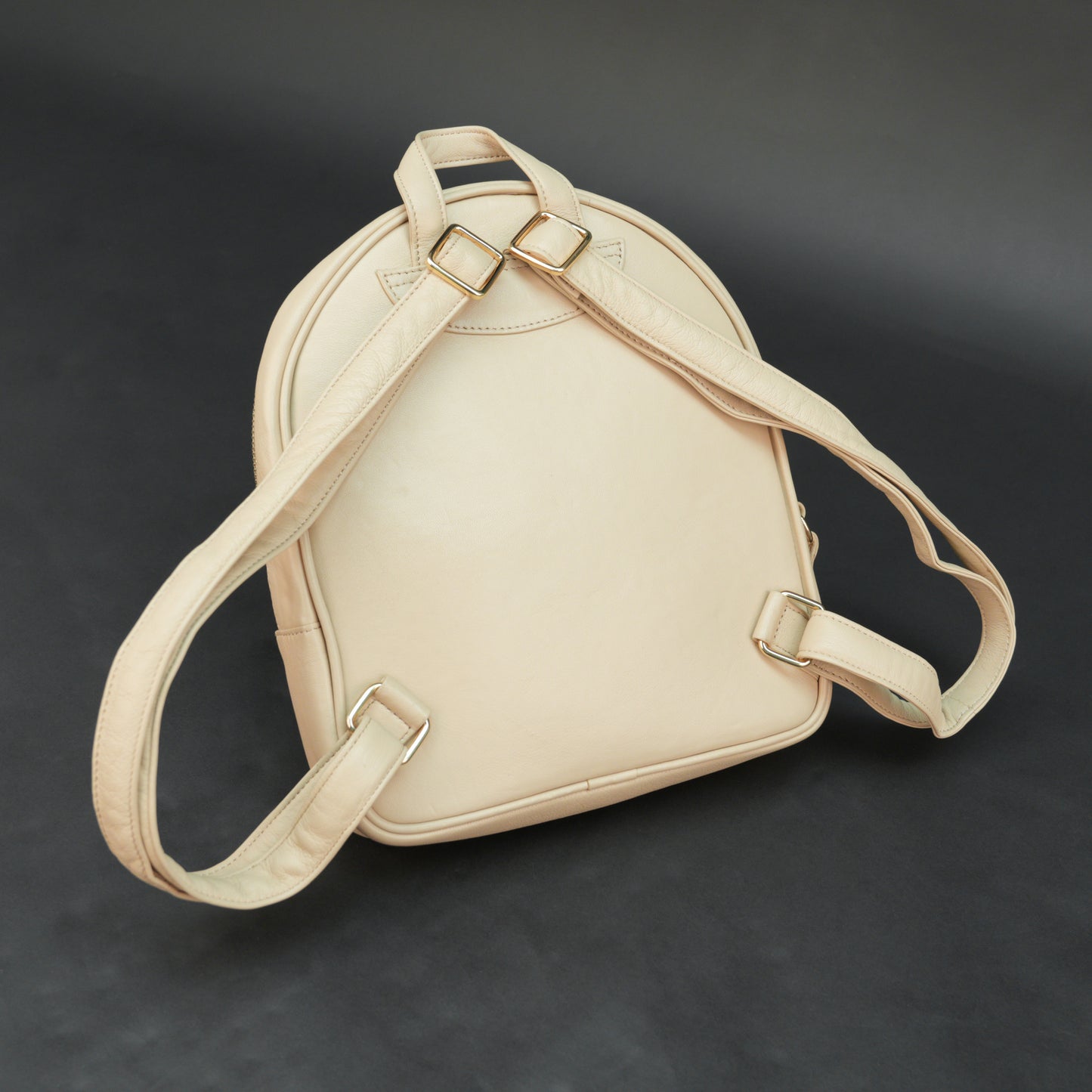 Backpack with adjustable straps, zipper pockets, and spacious main compartment.