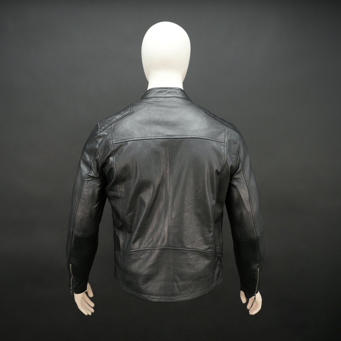 Black jacket with front zip closure, snap-button collar, zippered cuffs, multiple pockets including two side pockets, one vertical front pocket, and one inner pocket, offering a stylish and functional everyday design