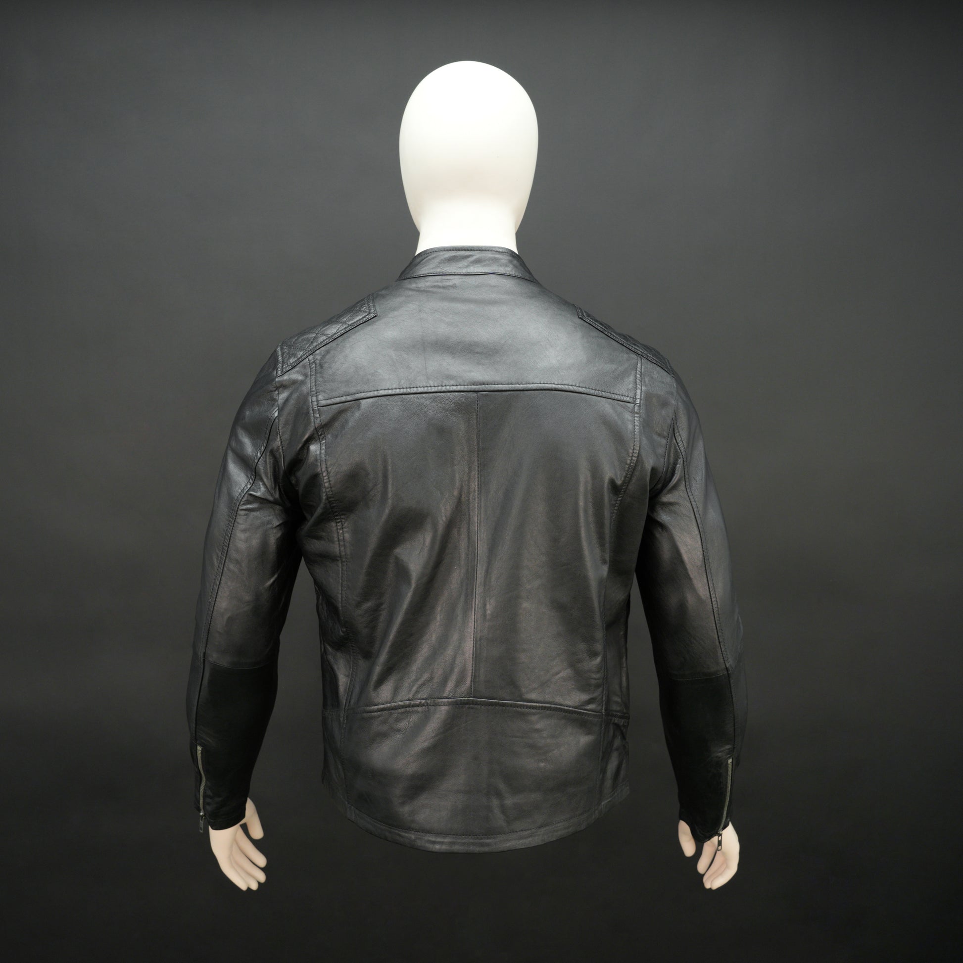 Black jacket with front zip closure, snap-button collar, zippered cuffs, multiple pockets including two side pockets, one vertical front pocket, and one inner pocket, offering a stylish and functional everyday design