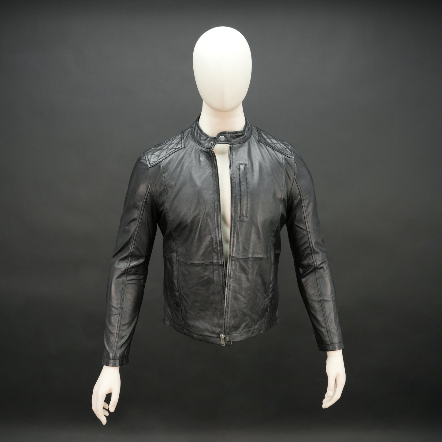 Black jacket with front zip closure, snap-button collar, zippered cuffs, multiple pockets including two side pockets, one vertical front pocket, and one inner pocket, offering a stylish and functional everyday design