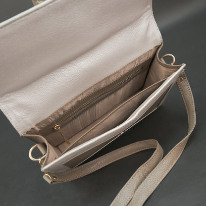 Camel leather crossbody handbag with zipper compartment.