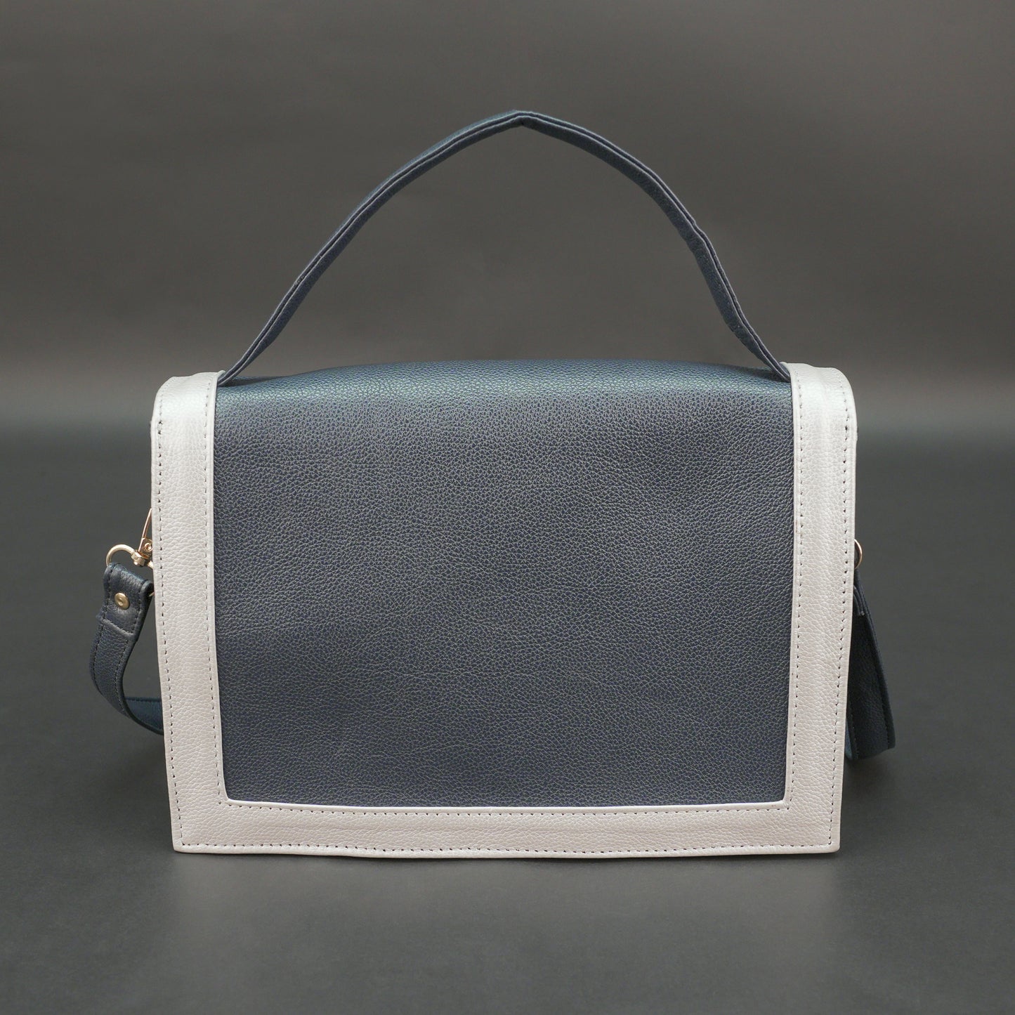 Dark blue leather crossbody handbag with zipper compartment and pocket.