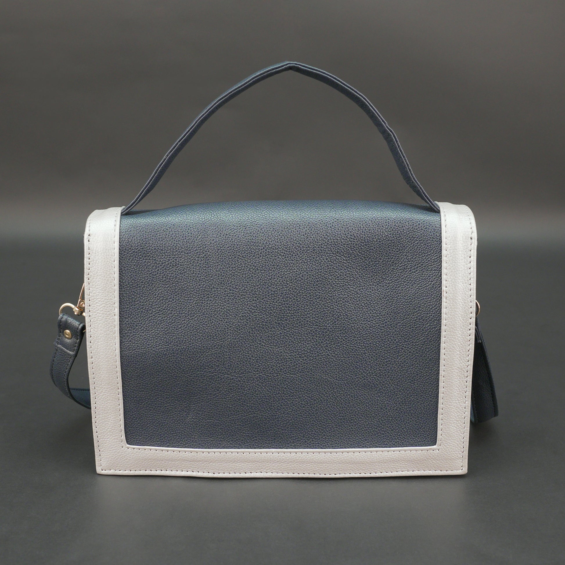 Dark blue leather crossbody handbag with zipper compartment and pocket.