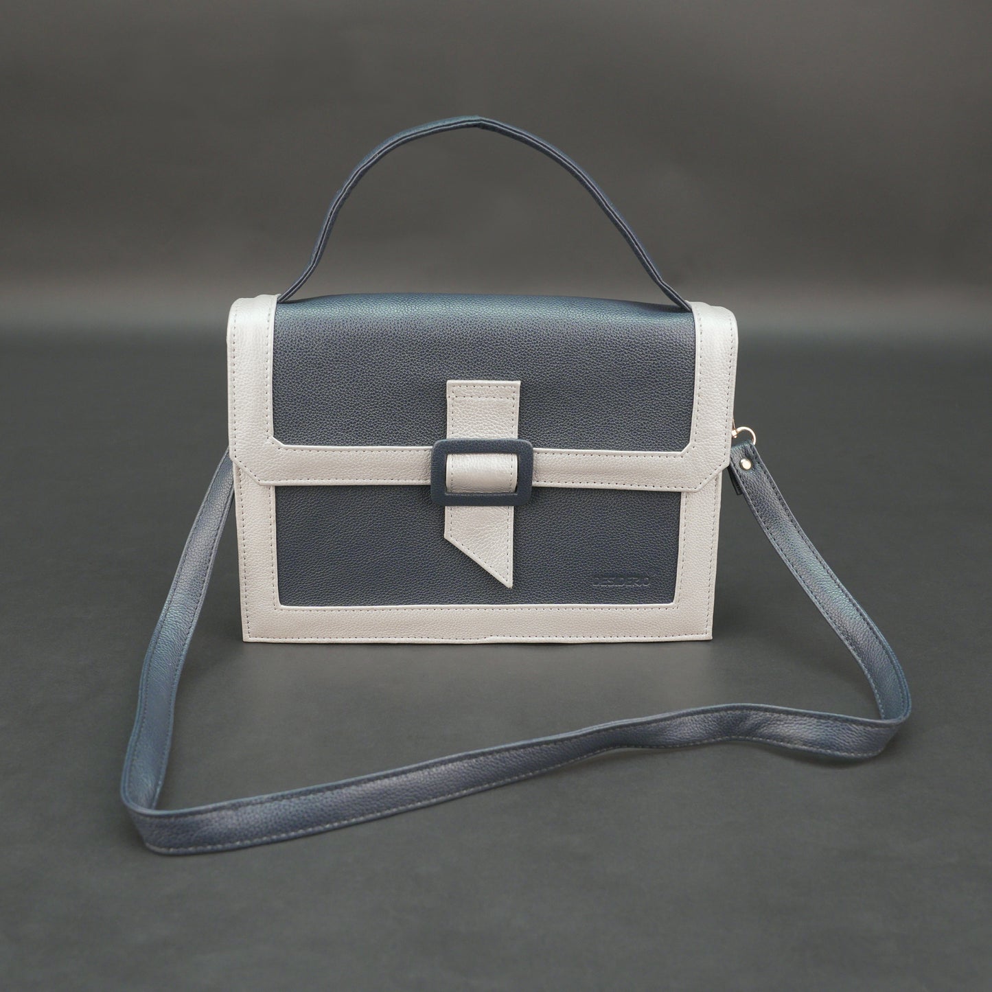 Dark blue leather crossbody handbag with zipper compartment and pocket.