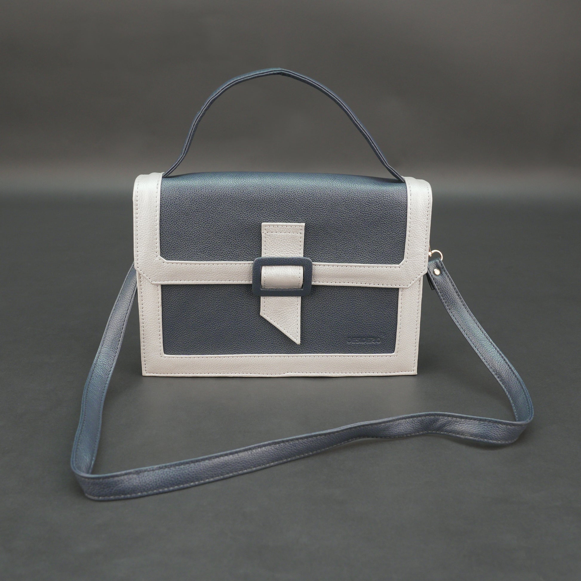 Dark blue leather crossbody handbag with zipper compartment and pocket.