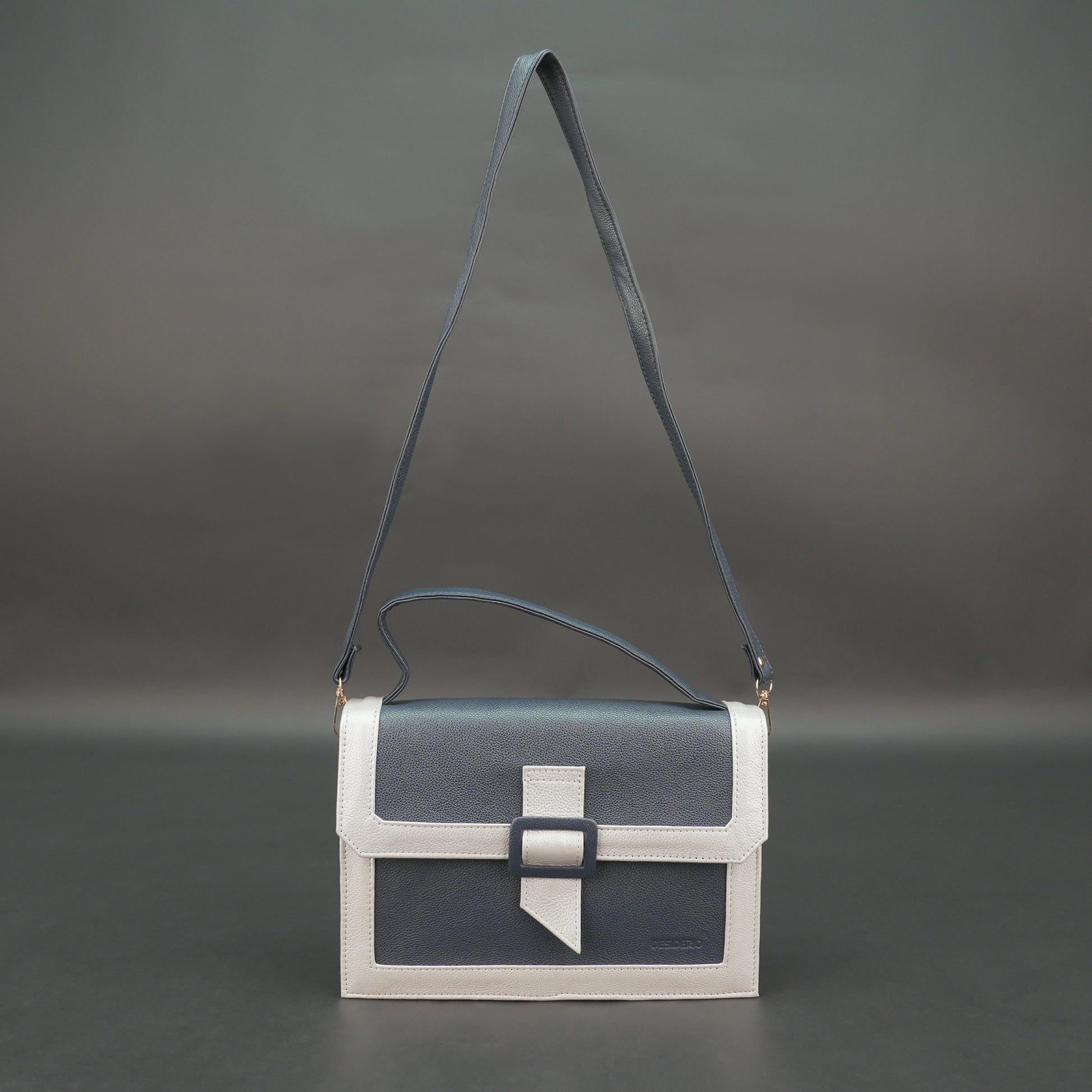 Dark blue leather crossbody handbag with zipper compartment and pocket.