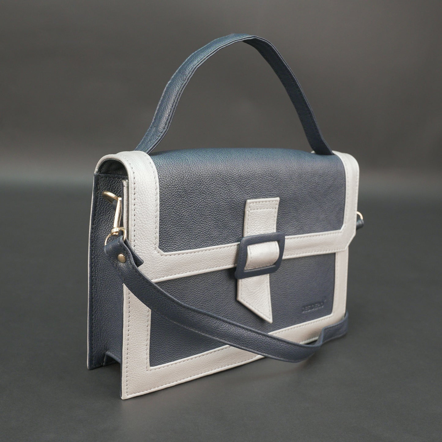 Dark blue leather crossbody handbag with zipper compartment and pocket.
