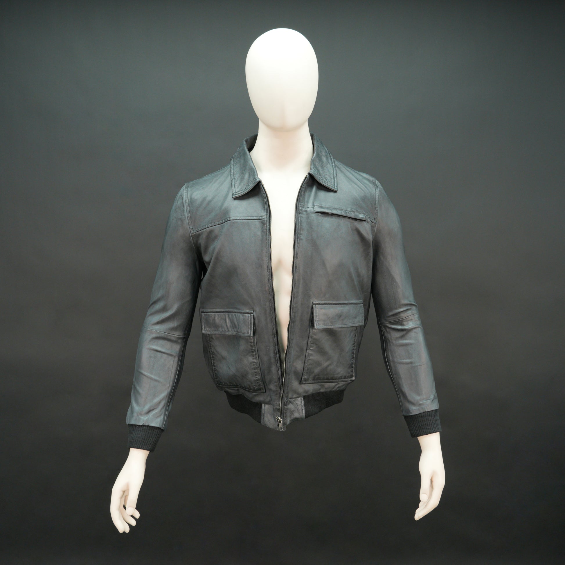 Men’s black leather jacket with zip closure, two side pockets, one left arm pocket, and one inside pocket, combining style and everyday functionality