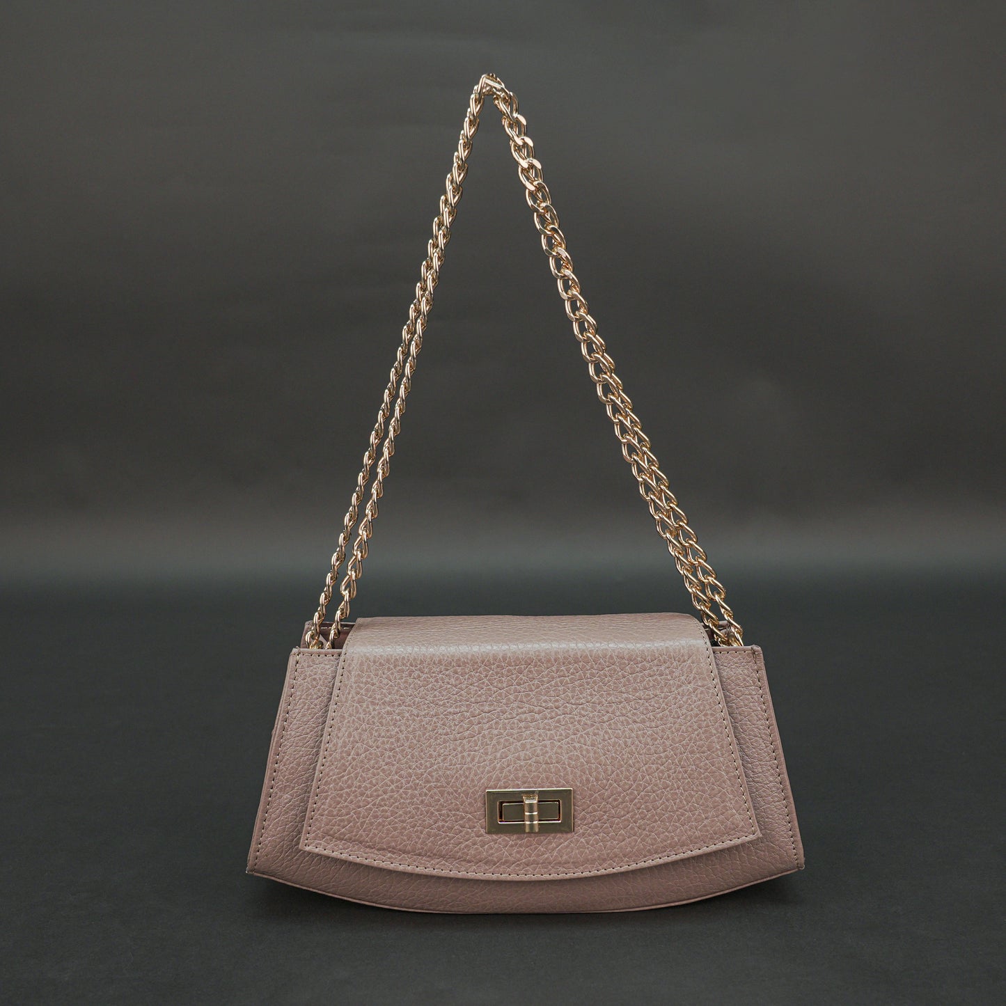 Brown real leather handbag with brass chain and zip compartment.