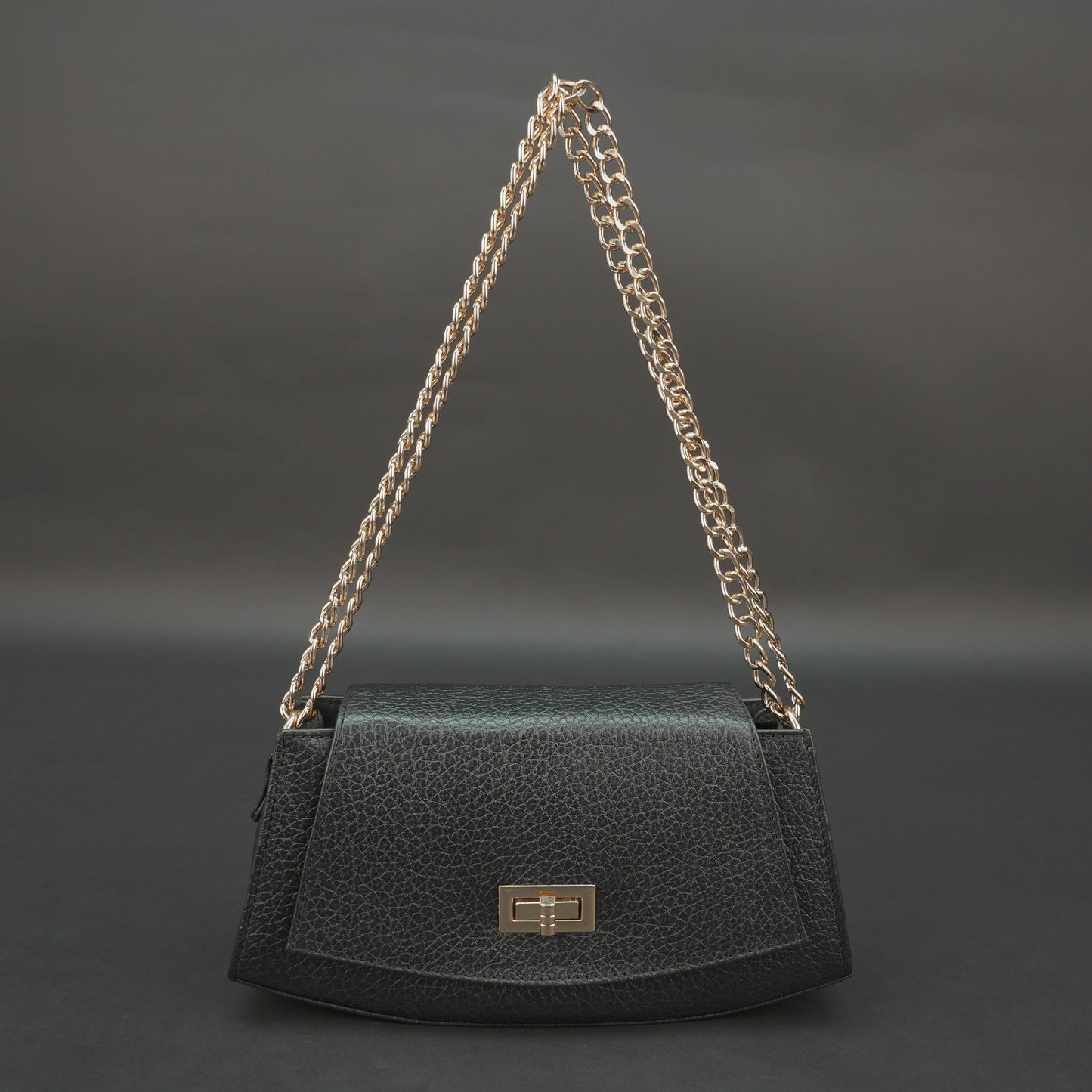 Black real leather handbag with brass chain and zip compartment.