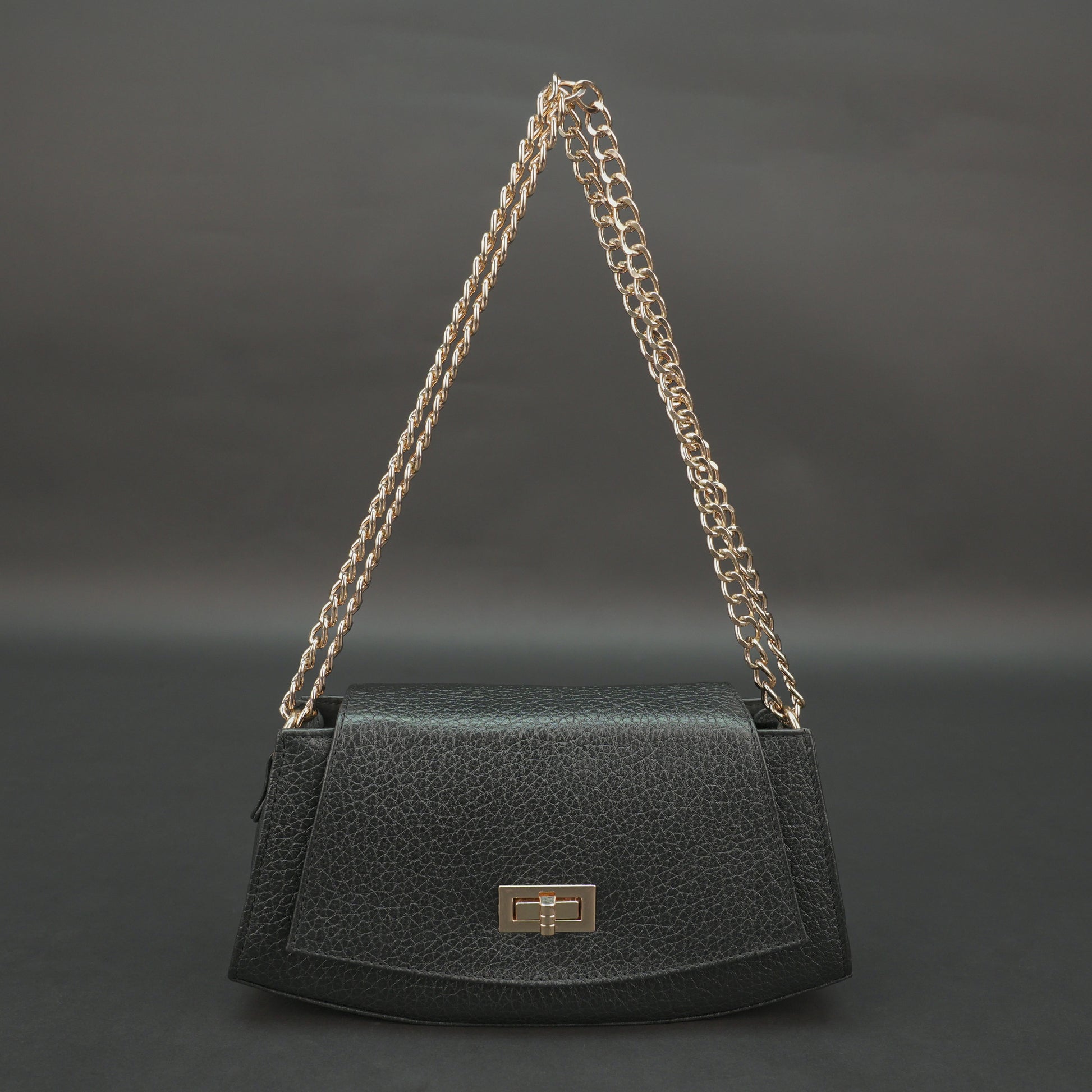 Black real leather handbag with brass chain and zip compartment.
