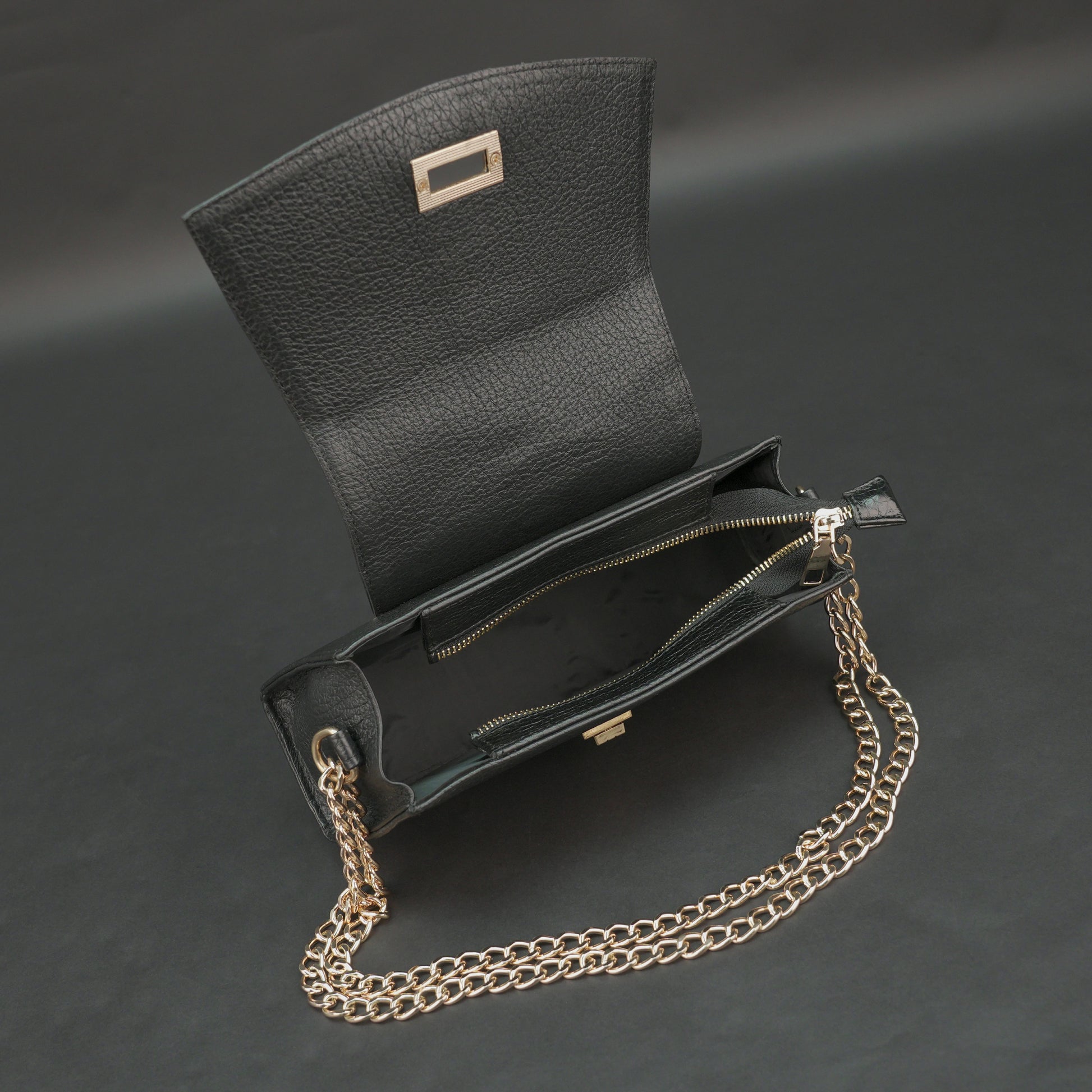 Black real leather handbag with brass chain and zip compartment.