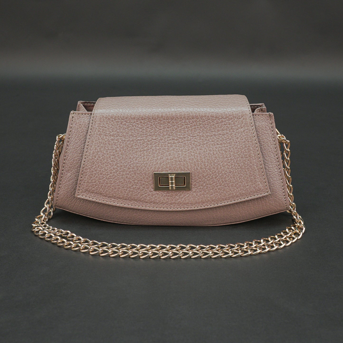 Brown real leather handbag with brass chain and zip compartment.