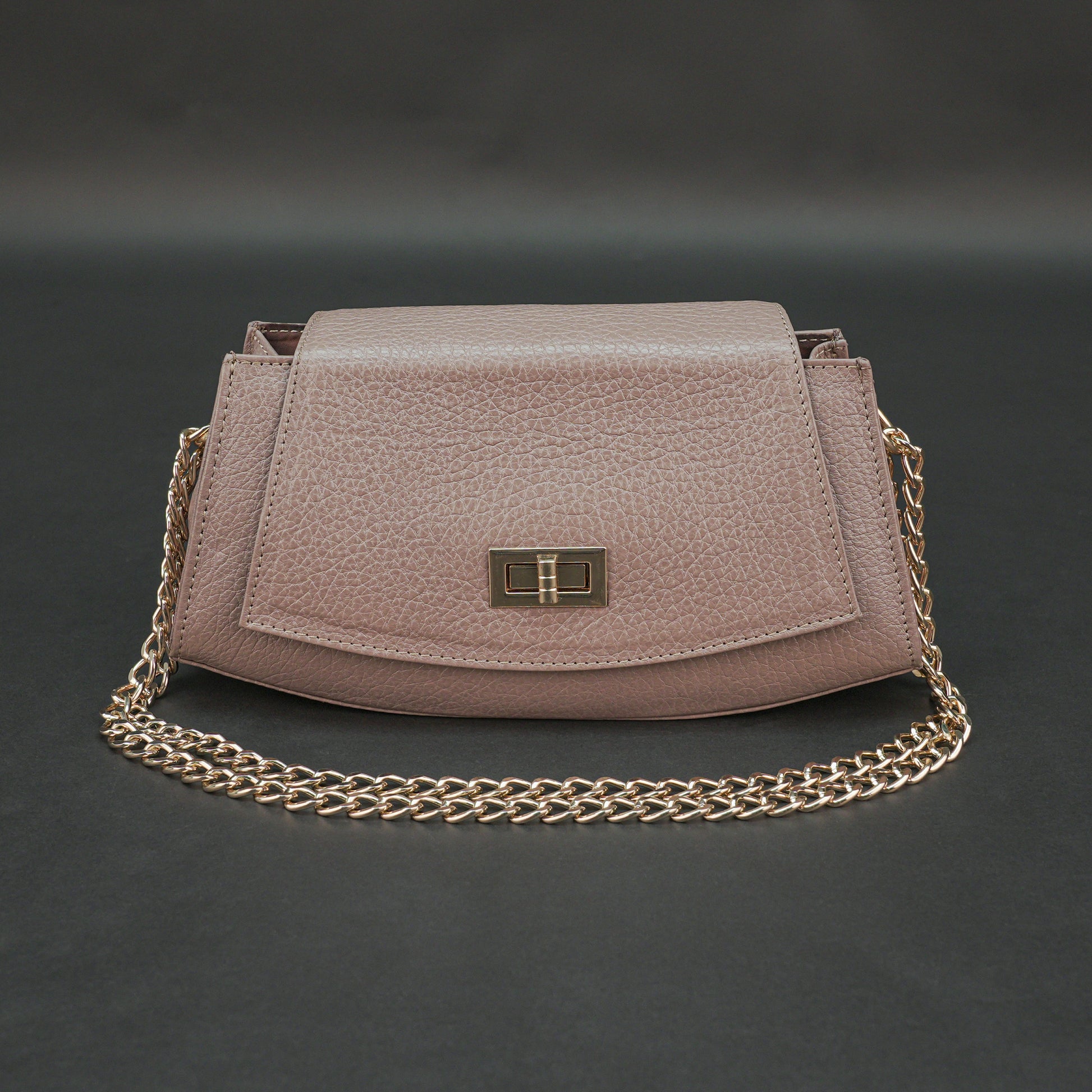 Brown real leather handbag with brass chain and zip compartment.