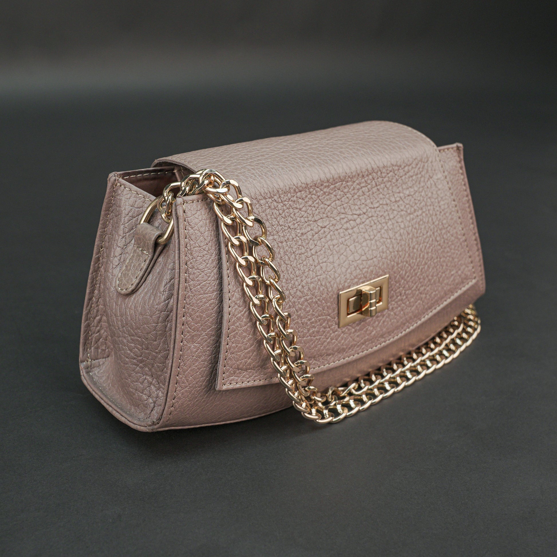 Brown real leather handbag with brass chain and zip compartment.