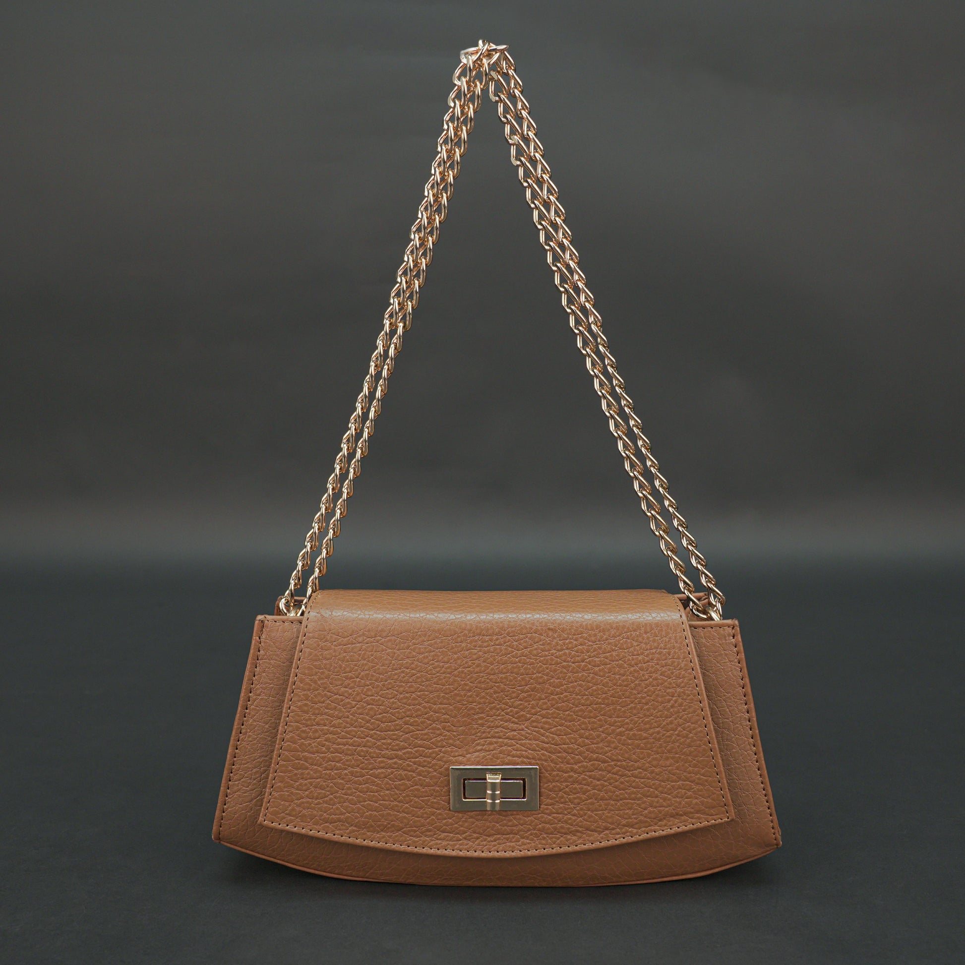 Tan leather handbag with chain and zipper.