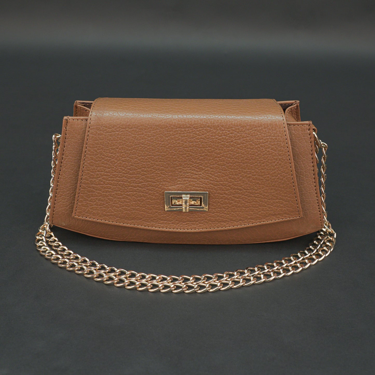 Tan leather handbag with chain and zipper.