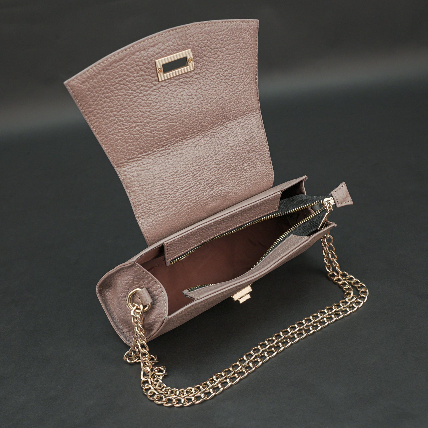 Brown real leather handbag with brass chain and zip compartment.
