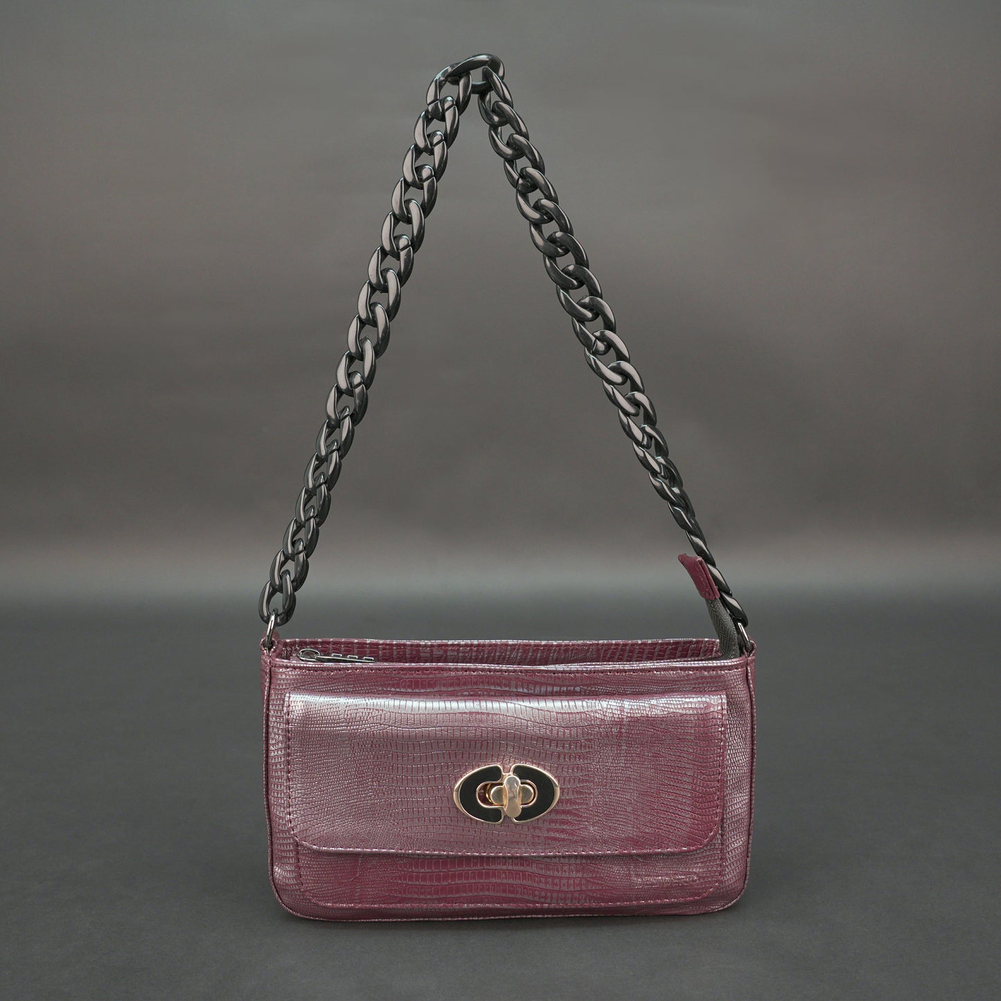 Maroon leather handbag with chain and pocket.