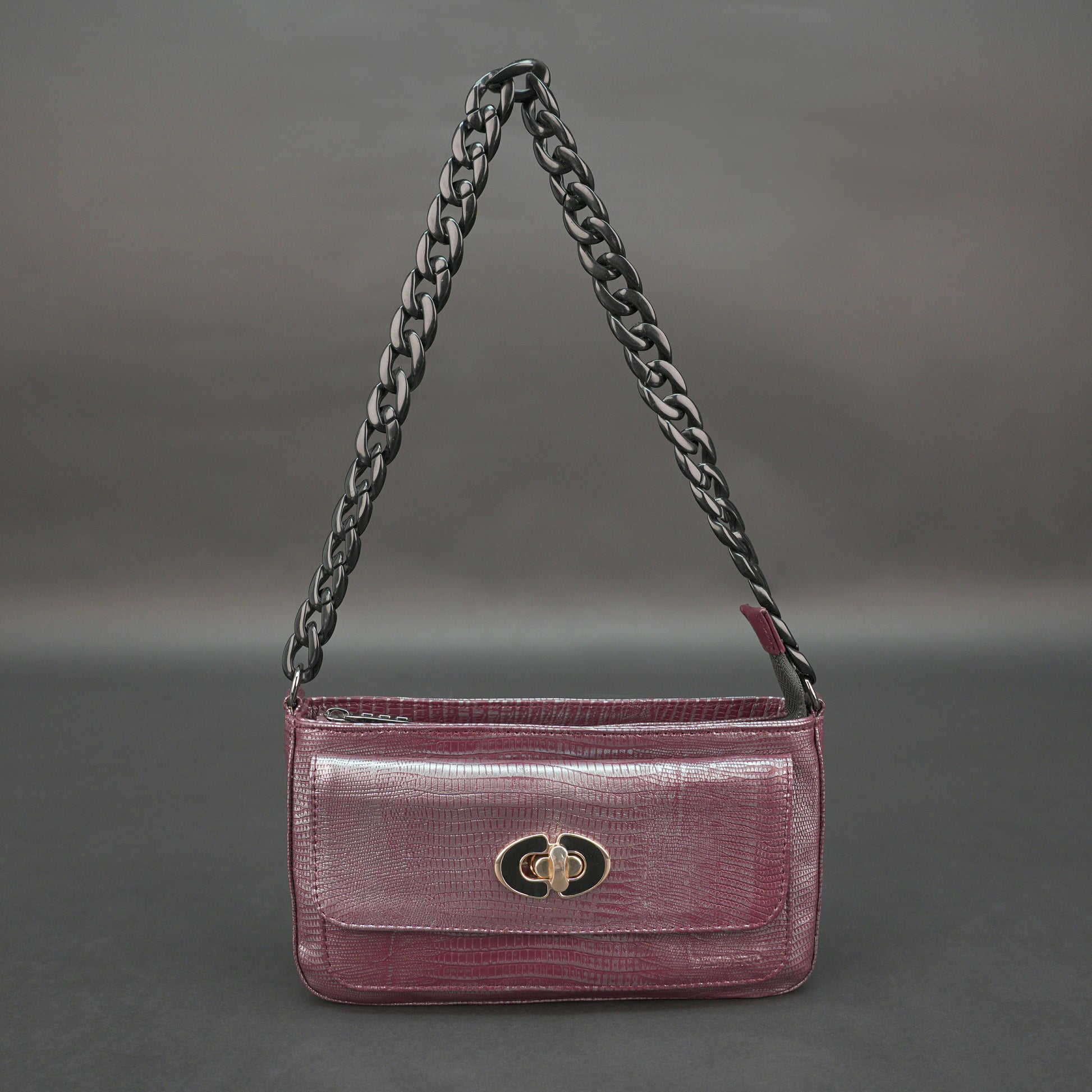 Maroon leather handbag with chain and pocket.