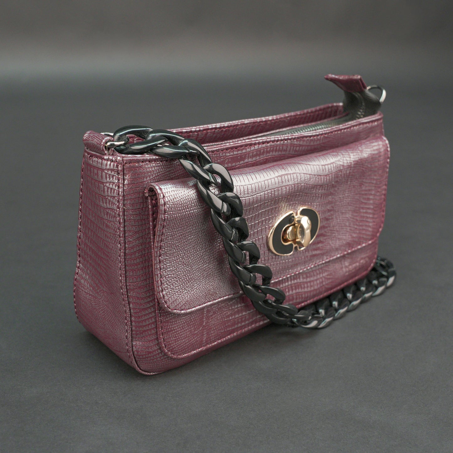 Maroon leather handbag with chain and pocket.