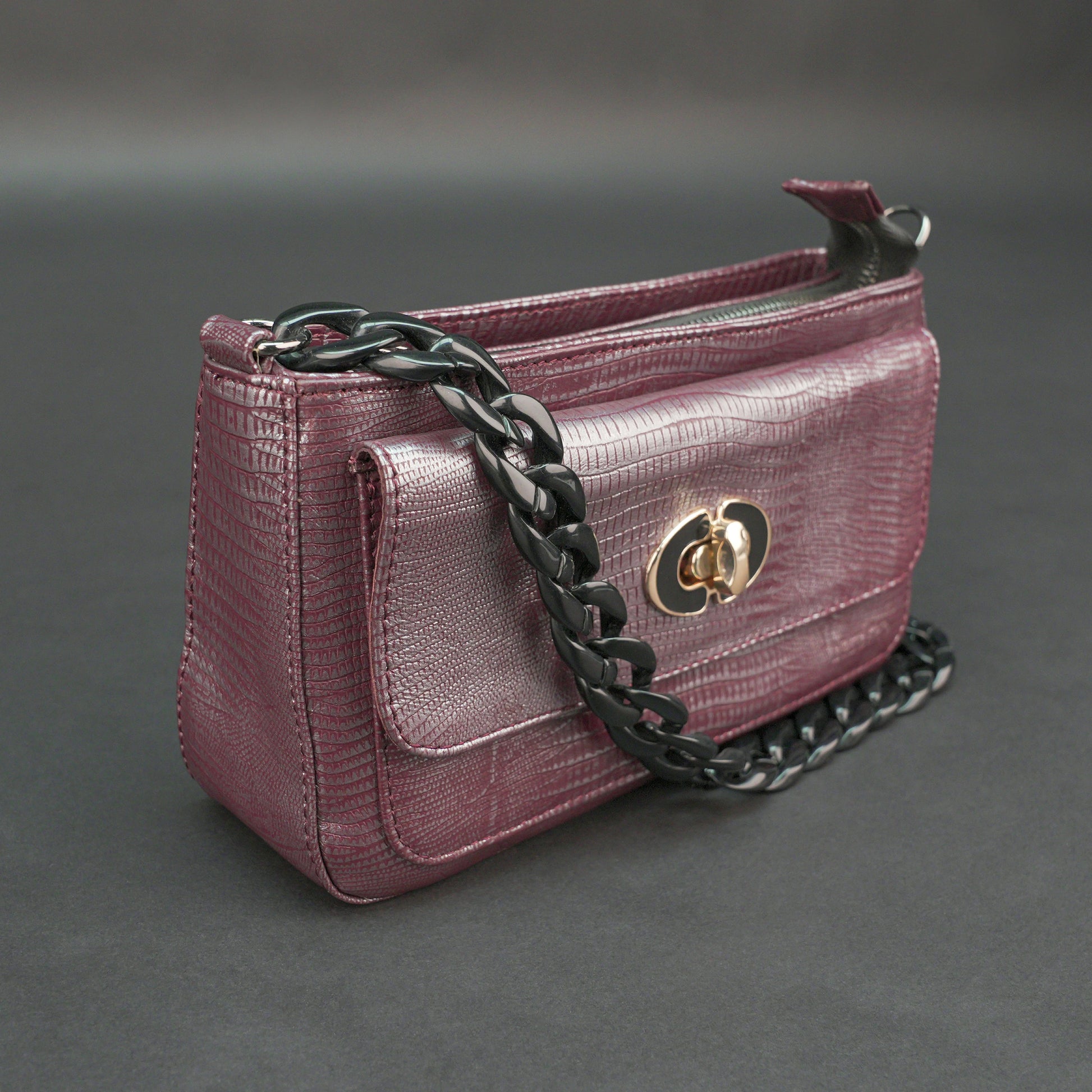 Maroon leather handbag with chain and pocket.