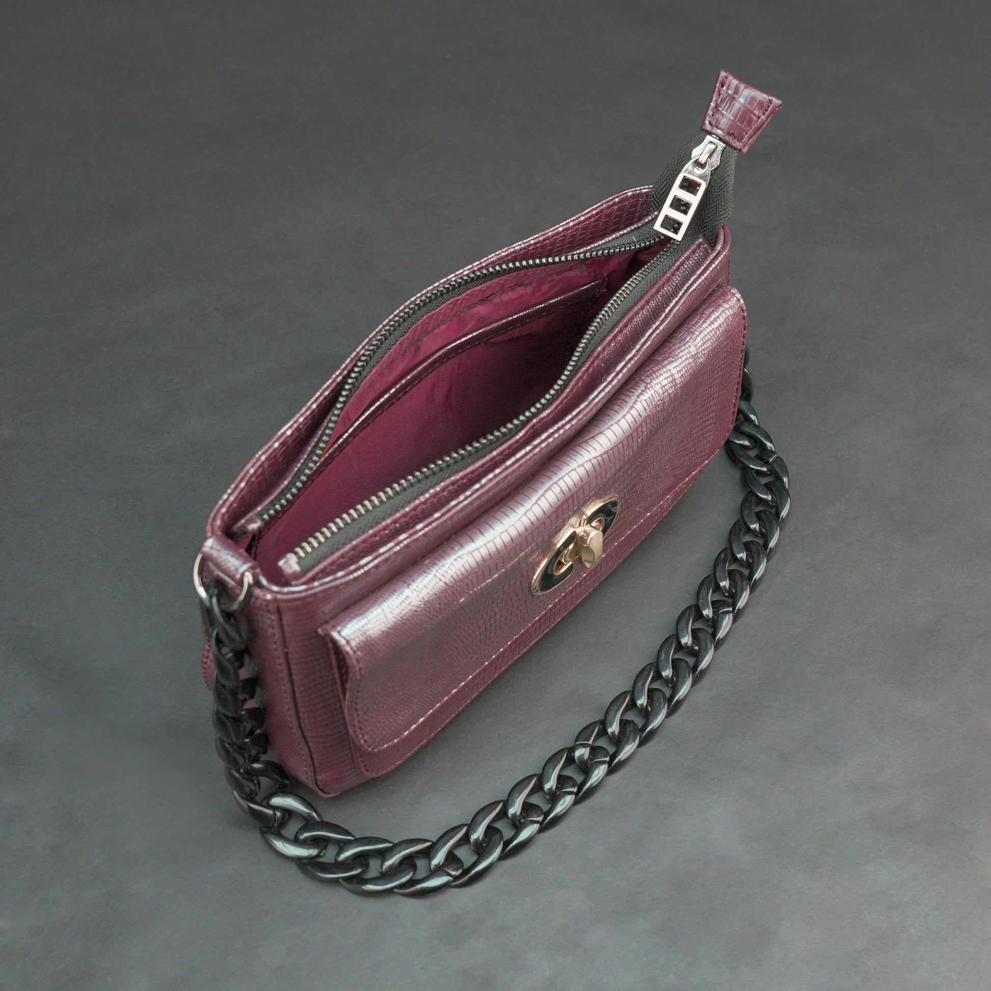 Maroon leather handbag with chain and pocket.