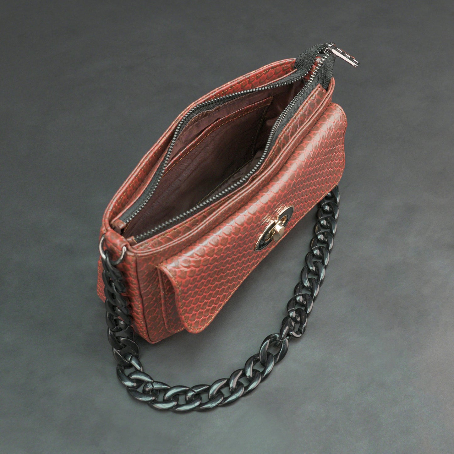 Brown leather handbag with metal chain and zipper compartment.