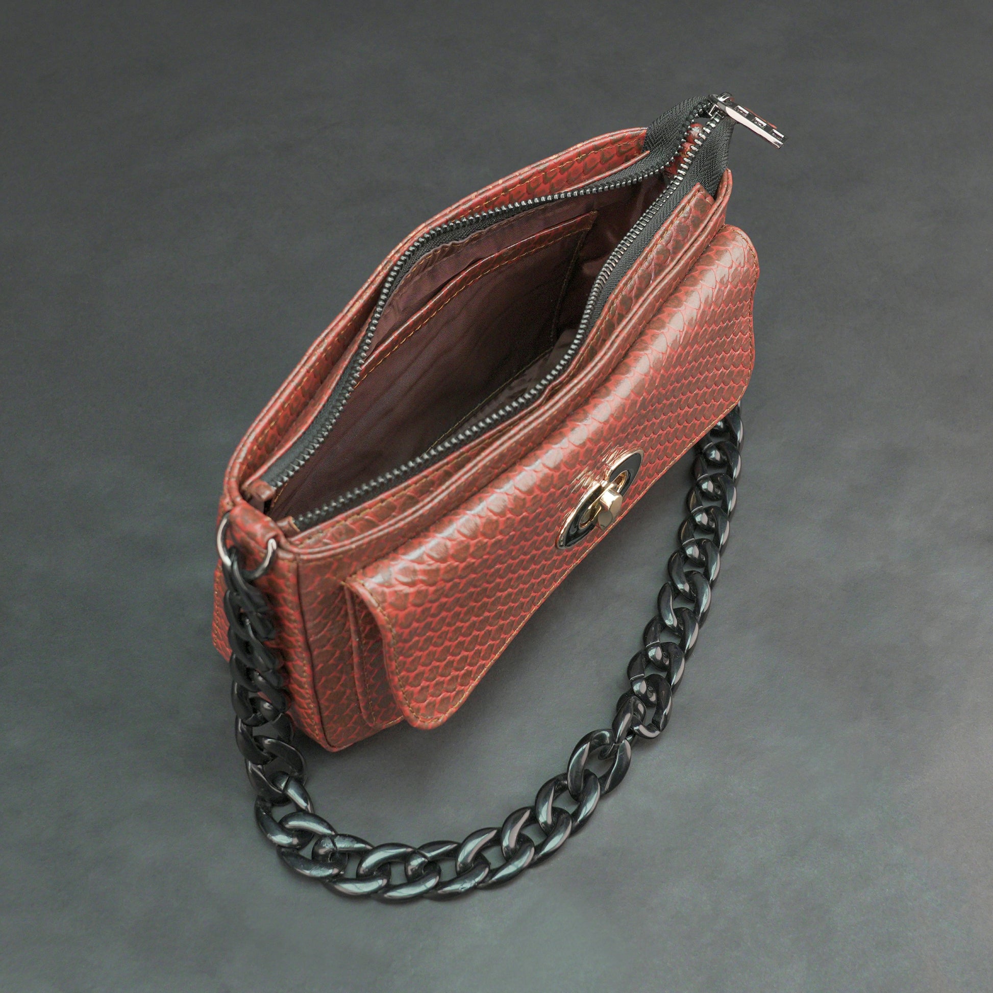 Brown leather handbag with metal chain and zipper compartment.
