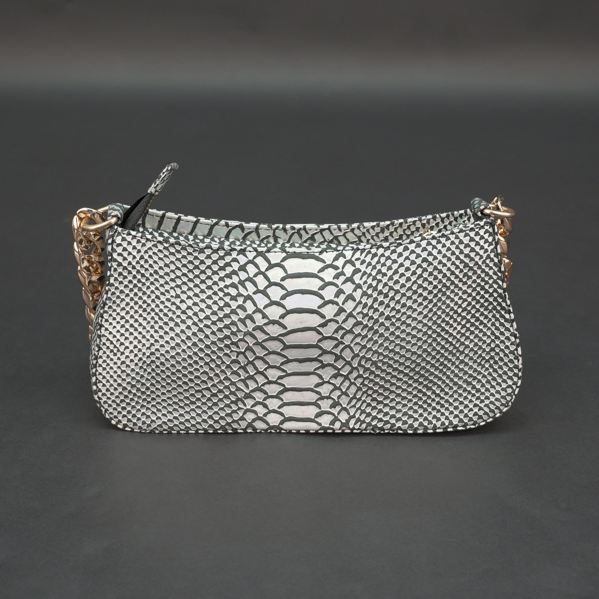 Real leather handbag with gold chain and zipper compartment.
