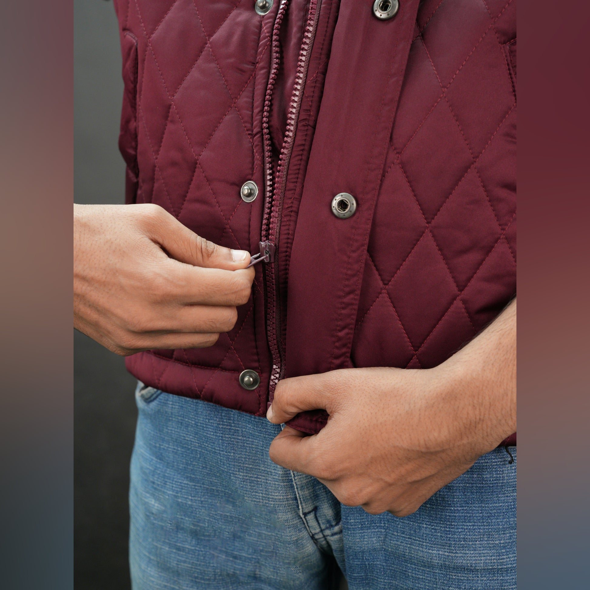 Maroon vest featuring a zip closure with snap button, two snap-button side pockets, and an inside pocket for secure, convenient storage